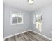 Cozy bedroom with gray walls, wood-look floors, and two windows at 328 Elva St, Anderson, IN 46013