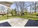 View of the backyard from the patio, featuring a basketball hoop and beautiful trees at 3375 Lincoln Rd, Indianapolis, IN 46222