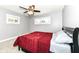 Bedroom with ceiling fan and red bedding at 3375 Lincoln Rd, Indianapolis, IN 46222