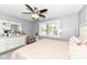 Spacious bedroom with large bed, dresser, and window at 3375 Lincoln Rd, Indianapolis, IN 46222