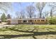 Charming single-story brick home with attached garage, front porch and mature trees and landscaping at 3375 Lincoln Rd, Indianapolis, IN 46222