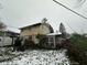 Back of house showing a screened porch and partially snow-covered yard at 4047 N Kitley Ave, Indianapolis, IN 46226