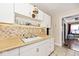 Clean kitchen with white cabinets, a double sink, and a view into the dining area at 426 N Euclid Ave, Indianapolis, IN 46201