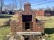 Brick barbeque pit in need of repair, located in backyard at 4349 Alhambra Dr, Anderson, IN 46013