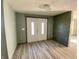 Renovated entryway with new flooring, double doors, and accent wall at 4349 Alhambra Dr, Anderson, IN 46013
