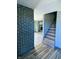 Renovated entryway with a dark brick accent wall and stairs at 4349 Alhambra Dr, Anderson, IN 46013