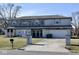 Two-story house needing repairs, featuring a large driveway and attached garage at 4349 Alhambra Dr, Anderson, IN 46013