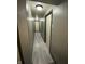 Long hallway with light grey wood flooring and neutral walls at 4349 Alhambra Dr, Anderson, IN 46013
