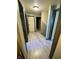 Long hallway with light grey wood flooring and neutral walls at 4349 Alhambra Dr, Anderson, IN 46013