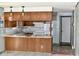 Kitchen with wood cabinets, white appliances, and a breakfast bar at 4349 Alhambra Dr, Anderson, IN 46013