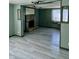 Living room with stone fireplace and light grey wood-look floors at 4349 Alhambra Dr, Anderson, IN 46013