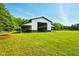 Outbuilding features a covered area with large doors provides ample storage or workshop space at 4450 W 300 N, Fairland, IN 46126