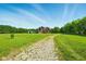 Traditional brick home with a long driveway, set on a large green lawn with surrounding trees at 4450 W 300 N, Fairland, IN 46126