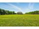 Expansive green lawn surrounds a traditional-style home on a sunny day, showcasing the property's vastness at 4450 W 300 N, Fairland, IN 46126
