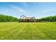 Inviting two-story home with a cozy front porch and pristine lawn offers suburban charm at 4450 W 300 N, Fairland, IN 46126