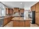 Kitchen with an island, wooden cabinetry, and stainless steel appliances at 4450 W 300 N, Fairland, IN 46126