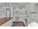 Renovated kitchen features white cabinets, quartz countertops, and a wood island at 4450 W 300 N, Fairland, IN 46126