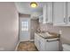Bright laundry room with white cabinets, countertop sink, and extra storage at 4450 W 300 N, Fairland, IN 46126