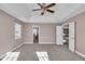 Main bedroom with carpet, ceiling fan, and access to bathroom and loft at 4450 W 300 N, Fairland, IN 46126