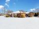 Brick home's side view, snow-covered yard at 4506 Winter Dr, Anderson, IN 46012