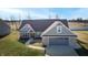 Single-story home with gray garage and manicured lawn at 4667 W Meadows Ln, New Palestine, IN 46163