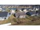 Aerial view of a neighborhood with houses and a pond at 4667 W Meadows Ln, New Palestine, IN 46163
