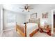 Charming bedroom featuring a wooden bed frame, window with blinds, and tasteful decor at 4667 W Meadows Ln, New Palestine, IN 46163