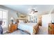 Spacious bedroom with wooden furniture and ceiling fan at 4667 W Meadows Ln, New Palestine, IN 46163