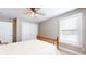 Well-lit bedroom with a wooden bed frame and white bedding, plus a large closet at 4667 W Meadows Ln, New Palestine, IN 46163