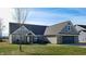 Brick ranch home with gray roof, attached garage, and landscaped lawn at 4667 W Meadows Ln, New Palestine, IN 46163