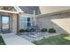 Charming front porch with a small sitting area and landscaping at 4667 W Meadows Ln, New Palestine, IN 46163