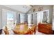 Bright sunroom with wooden table and chairs, offering backyard access at 4667 W Meadows Ln, New Palestine, IN 46163