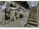 Unfinished basement with washer, dryer and staircase at 5201 N White Ln, Lawrence, IN 46226