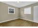 Bedroom with hardwood floors, neutral walls, and two windows at 5201 N White Ln, Lawrence, IN 46226