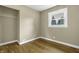 Bedroom with hardwood floors, neutral walls, and a closet at 5201 N White Ln, Lawrence, IN 46226