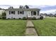 Ranch style home with gray exterior, landscaped lawn, and walkway at 5201 N White Ln, Lawrence, IN 46226