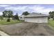 Single car garage with white siding and asphalt driveway at 5201 N White Ln, Lawrence, IN 46226