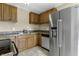 Modern kitchen with stainless steel appliances and wood cabinets at 5201 N White Ln, Lawrence, IN 46226