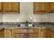 Kitchen sink with granite countertop and wood cabinets at 5201 N White Ln, Lawrence, IN 46226