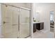 Bright bathroom featuring walk-in shower with glass doors, double vanity, and tiled floors at 5670 Terracotta Trce, McCordsville, IN 46055