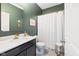 Well-lit bathroom featuring black vanity, gold fixtures, and shower at 5670 Terracotta Trce, McCordsville, IN 46055