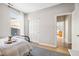 Light-filled bedroom with a bed, closet, and view into another room at 5670 Terracotta Trce, McCordsville, IN 46055