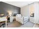 Well-lit bedroom with a bed, desk, and a large window, creating a cozy and functional space at 5670 Terracotta Trce, McCordsville, IN 46055