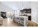 This open concept kitchen boasts a large island with seating and stainless steel appliances at 5670 Terracotta Trce, McCordsville, IN 46055