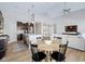 Open-concept kitchen with modern appliances and island seating flowing into dining and living areas at 5670 Terracotta Trce, McCordsville, IN 46055
