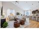 Open-concept living room with vaulted ceilings, modern furniture, and abundant natural light at 5670 Terracotta Trce, McCordsville, IN 46055