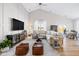 Bright living area showcasing a vaulted ceiling, large sectional sofa, and a view into the dining area at 5670 Terracotta Trce, McCordsville, IN 46055