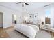 A bright main bedroom featuring a ceiling fan and an ensuite bathroom at 5670 Terracotta Trce, McCordsville, IN 46055