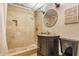Well-lit bathroom with elegant vanity, walk-in shower with stone tile and modern fixtures at 643 Fort Wayne Ave # H, Indianapolis, IN 46204