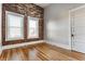 This bedroom offers exposed brick, hardwood floors, and natural light from the two windows at 643 Fort Wayne Ave # H, Indianapolis, IN 46204
